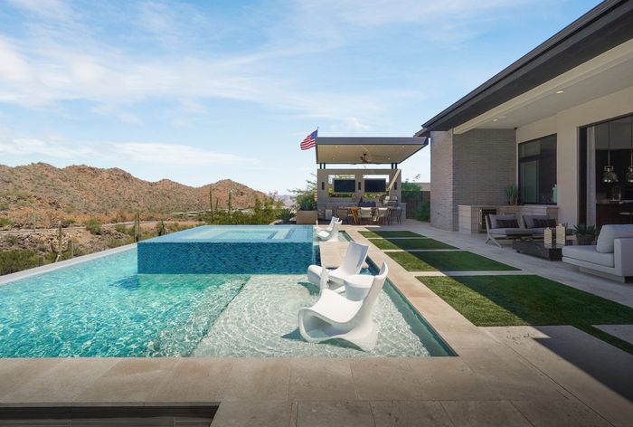 The infinity pool, spa, and ramada at the Adero Canyon model home