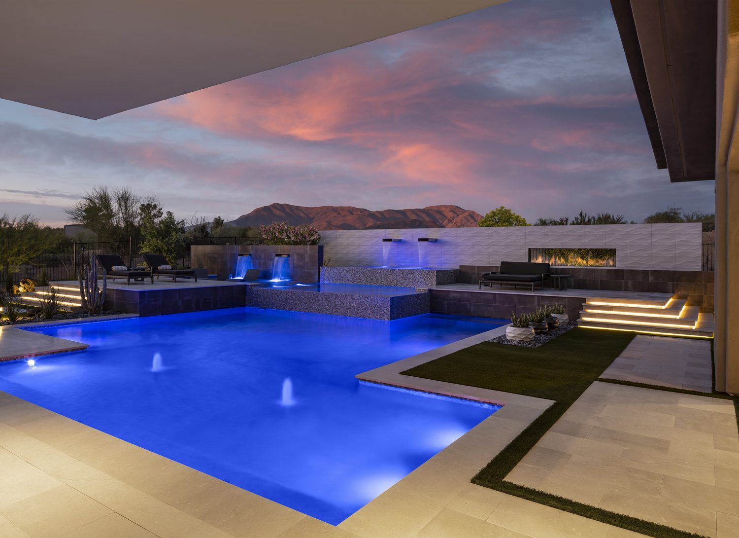 Illuminated custom pool and spa at dusk